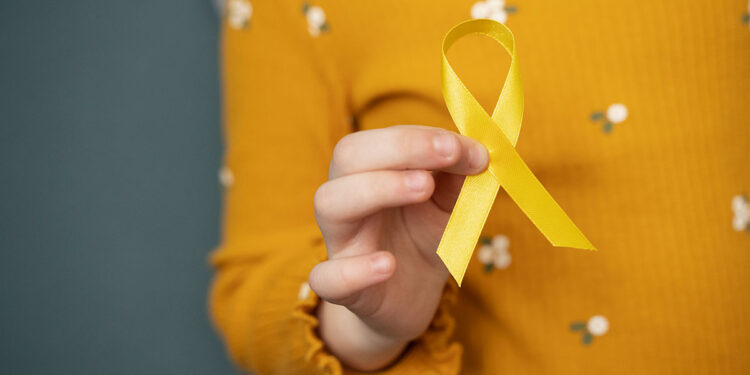 child-holding-yellow-ribbon