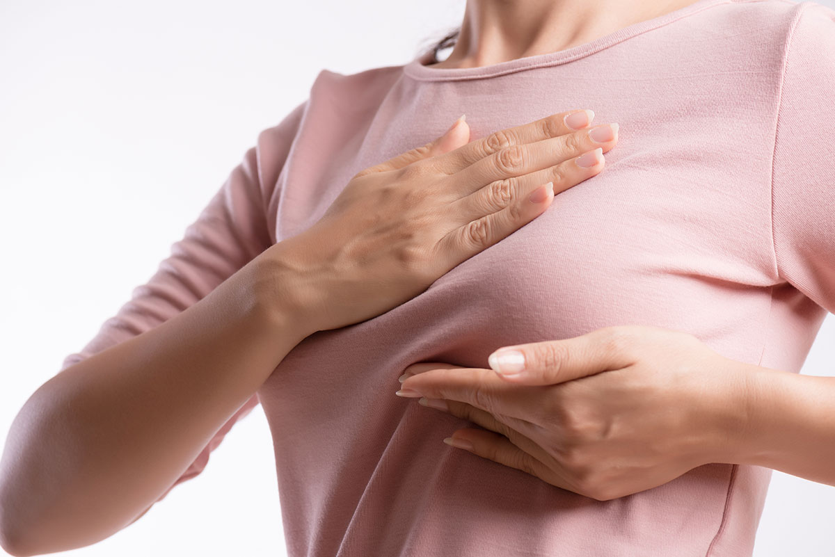 woman-hand-checking-lumps-on-her-breast-for-signs-of-breast-cancer