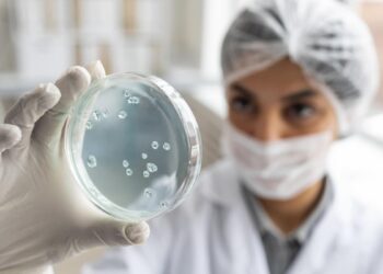 close-up-blurry-scientist-holding-petri-dish